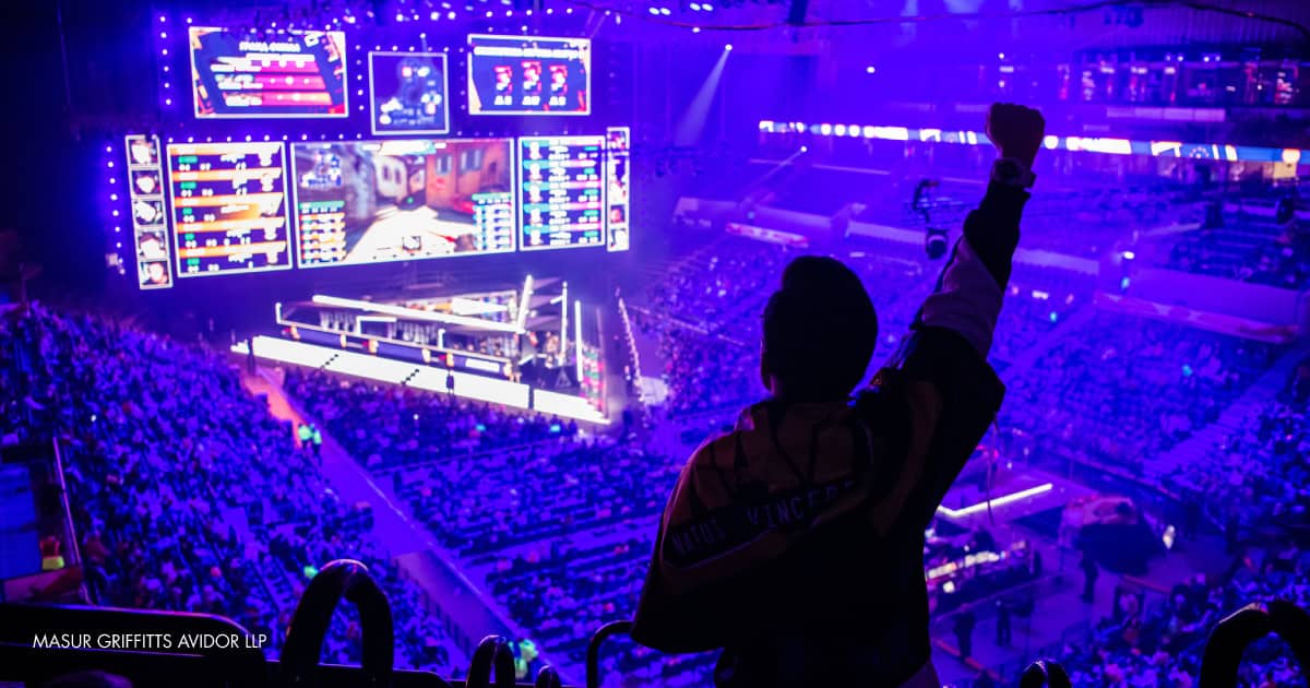 man raising arm at esports event